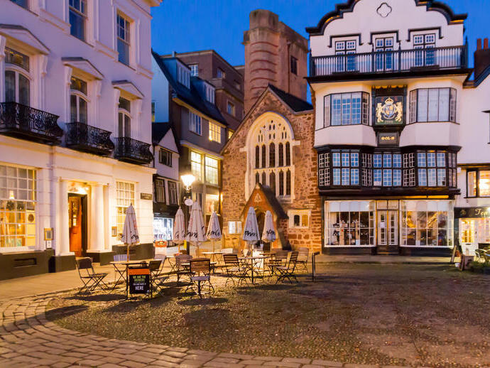 A quaint English town square in the evening.