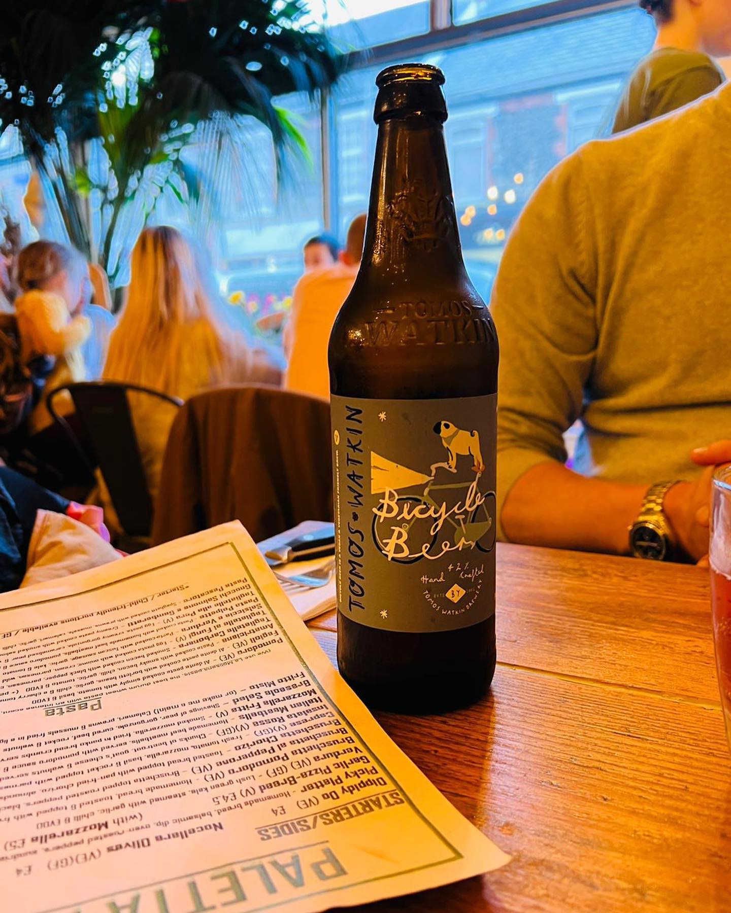 People enjoying a beer at Tomos Watkin Brewery