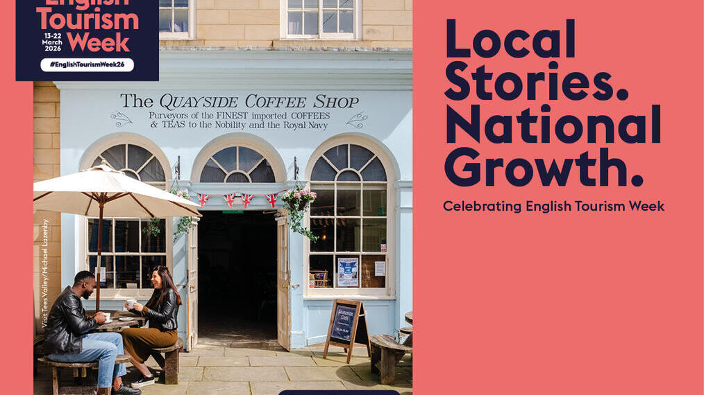 Outdoor scene of two people at a café, The Quayside Coffee Shop, in Tees Valley promoting English Tourism Week with banners and campaign slogan.