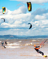 Eine Gruppe von Menschen beim Kitesurfen vor der Küste von Lancashire