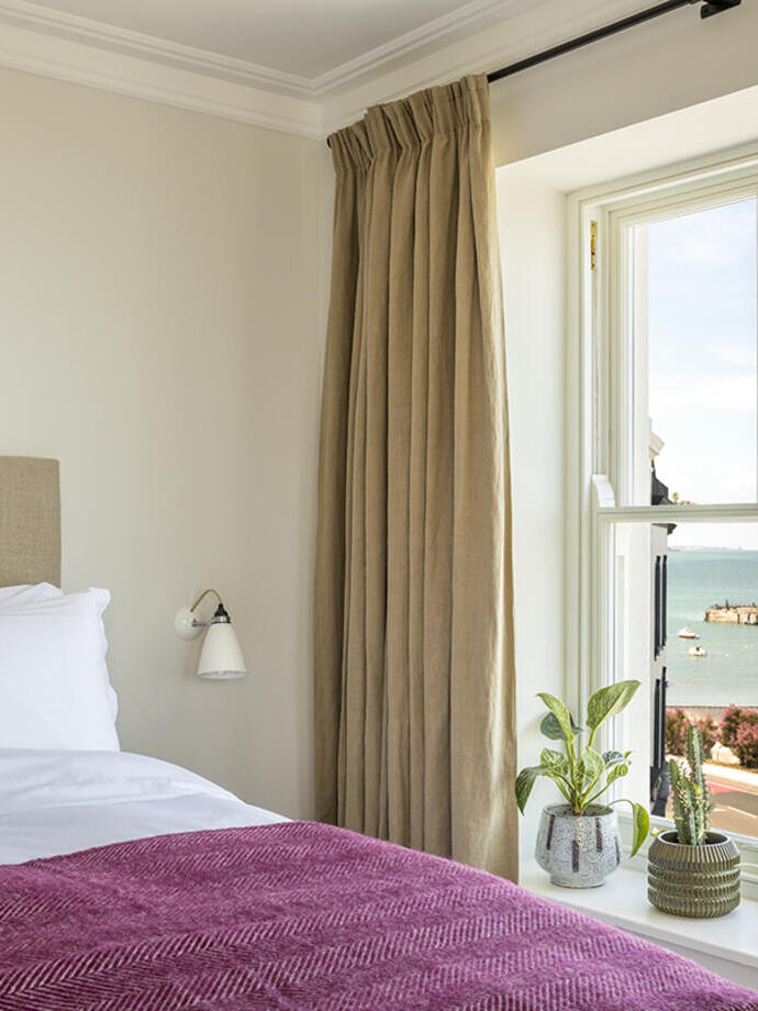 The ocean view of a room in a boutique hotel in a seaside town.