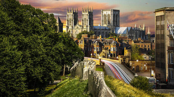 A minster in the centre of a city taken from the city stone wall