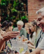 Groups of people sitting outside and drinking