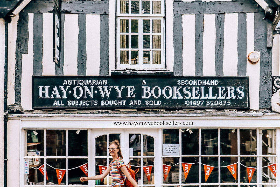 Woman walking past a bookshop