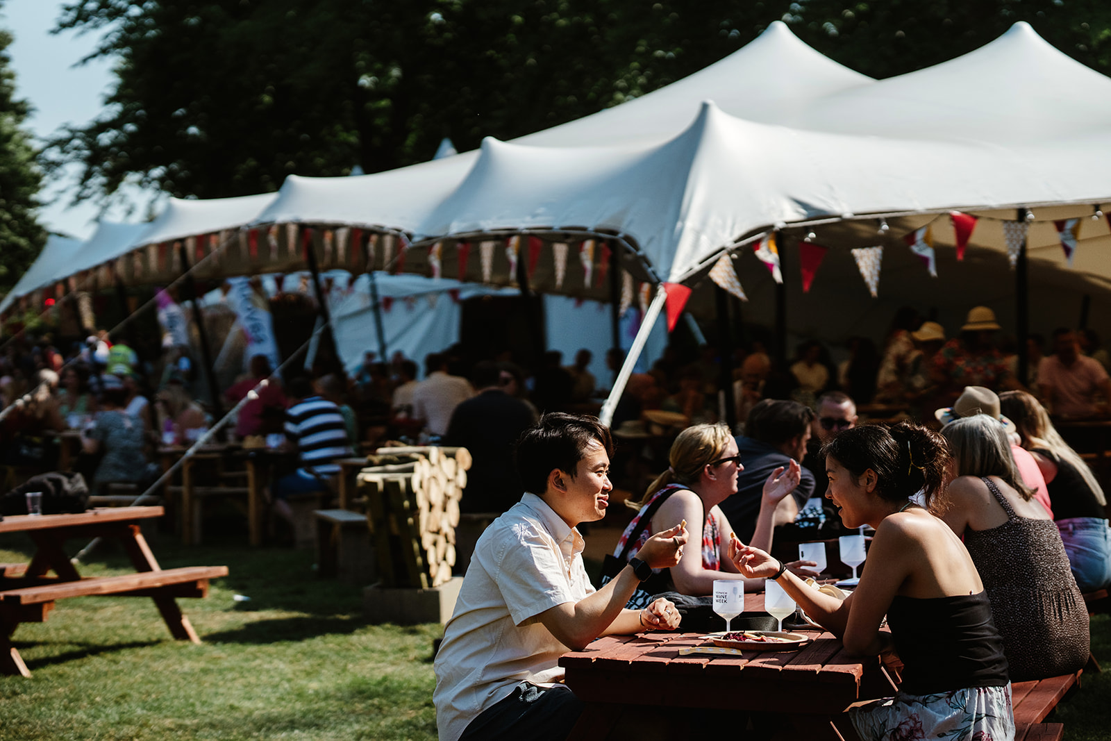 Groups of people sitting at tables and drinking wine at Norwich Wine Festival