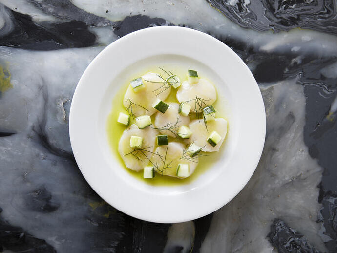 A fine dining plate of scallop cevice.
