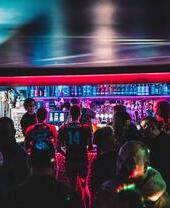 A group of people waiting at the bar inside Masquerade Bar, Liverpool