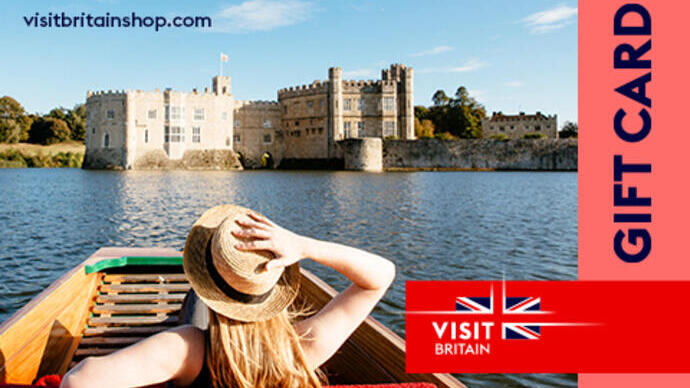 Woman in a punt on the moat looking towards castle