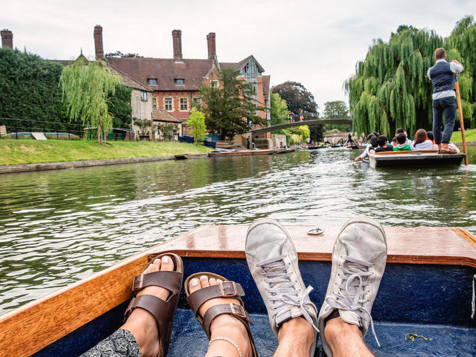 Two feet inside a boat; punting on a river