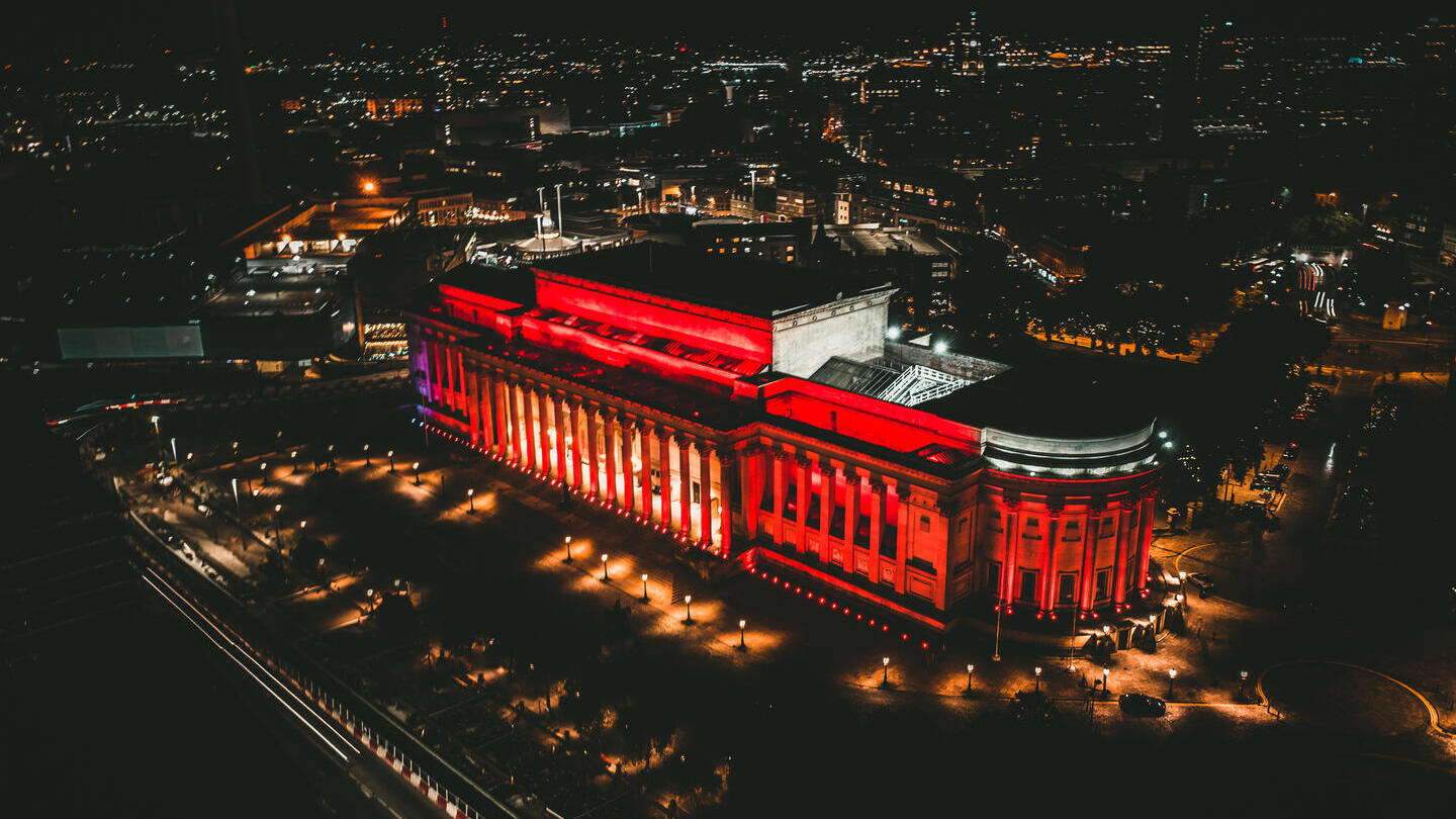 Aerial view of building lit up at night