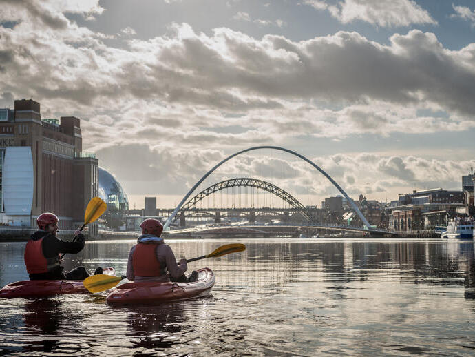 Couple kayaking in a city river.