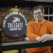 Woman standing near brewery sign at National Forest eBikes