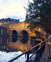 Couple strolling beside a canal in the evening