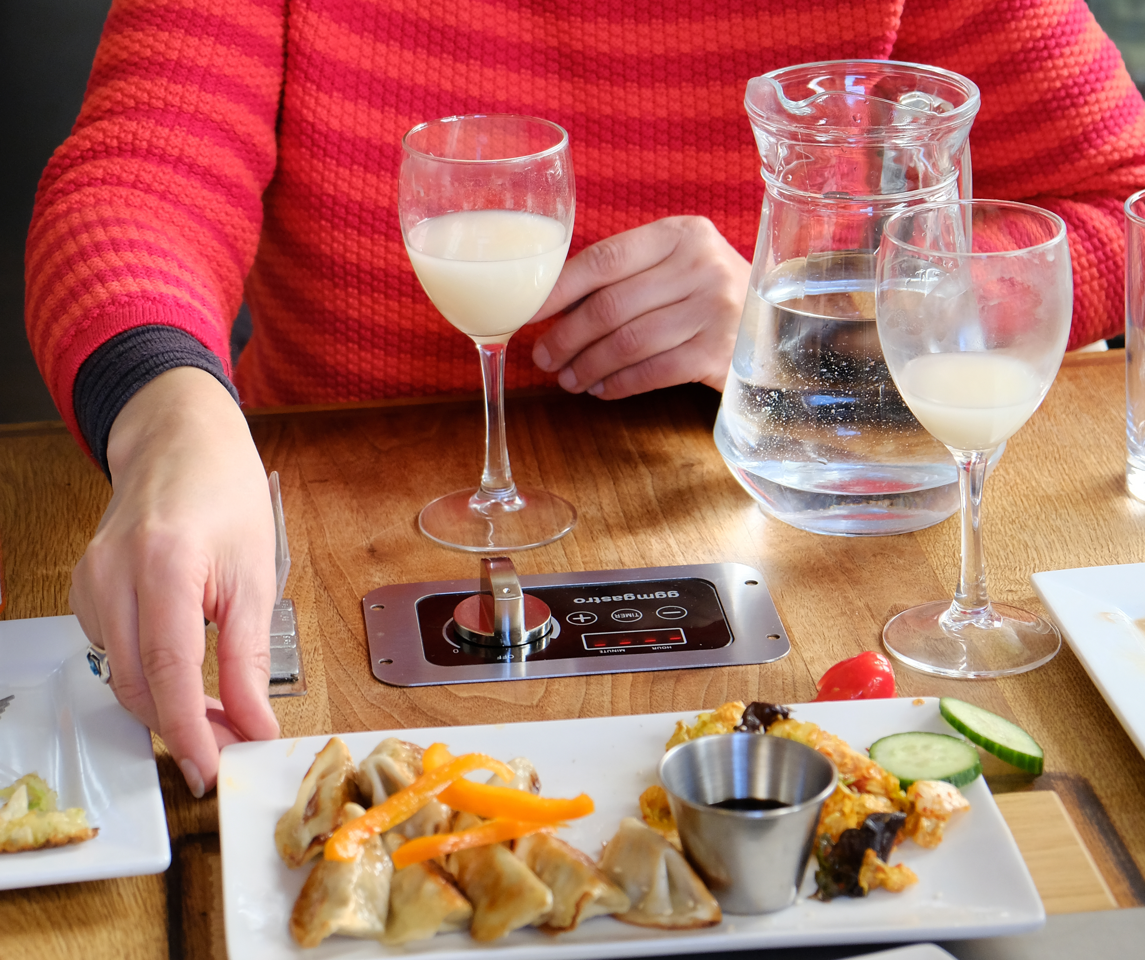A person enjoying food and drink at a table
