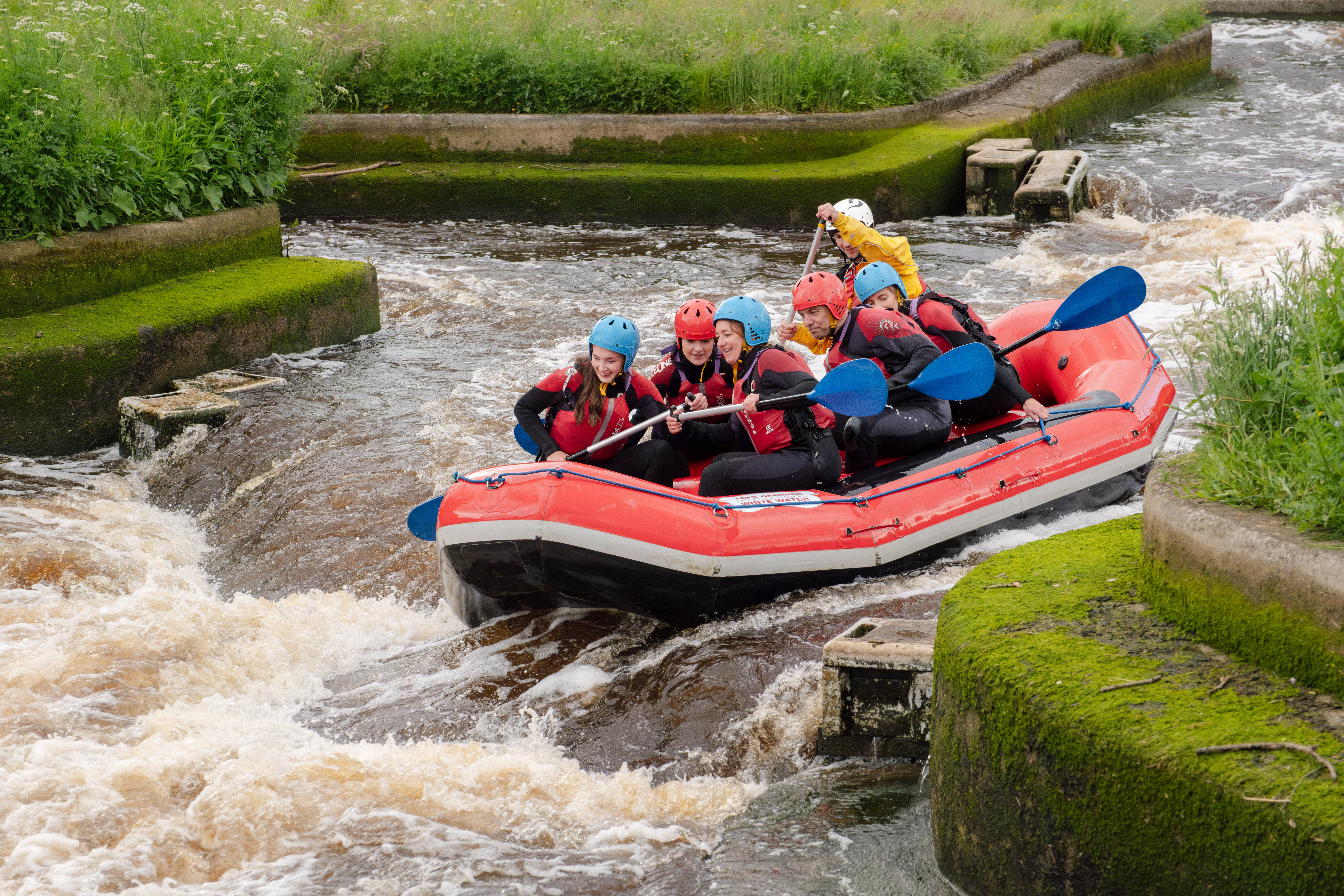 Group of people white water rafting