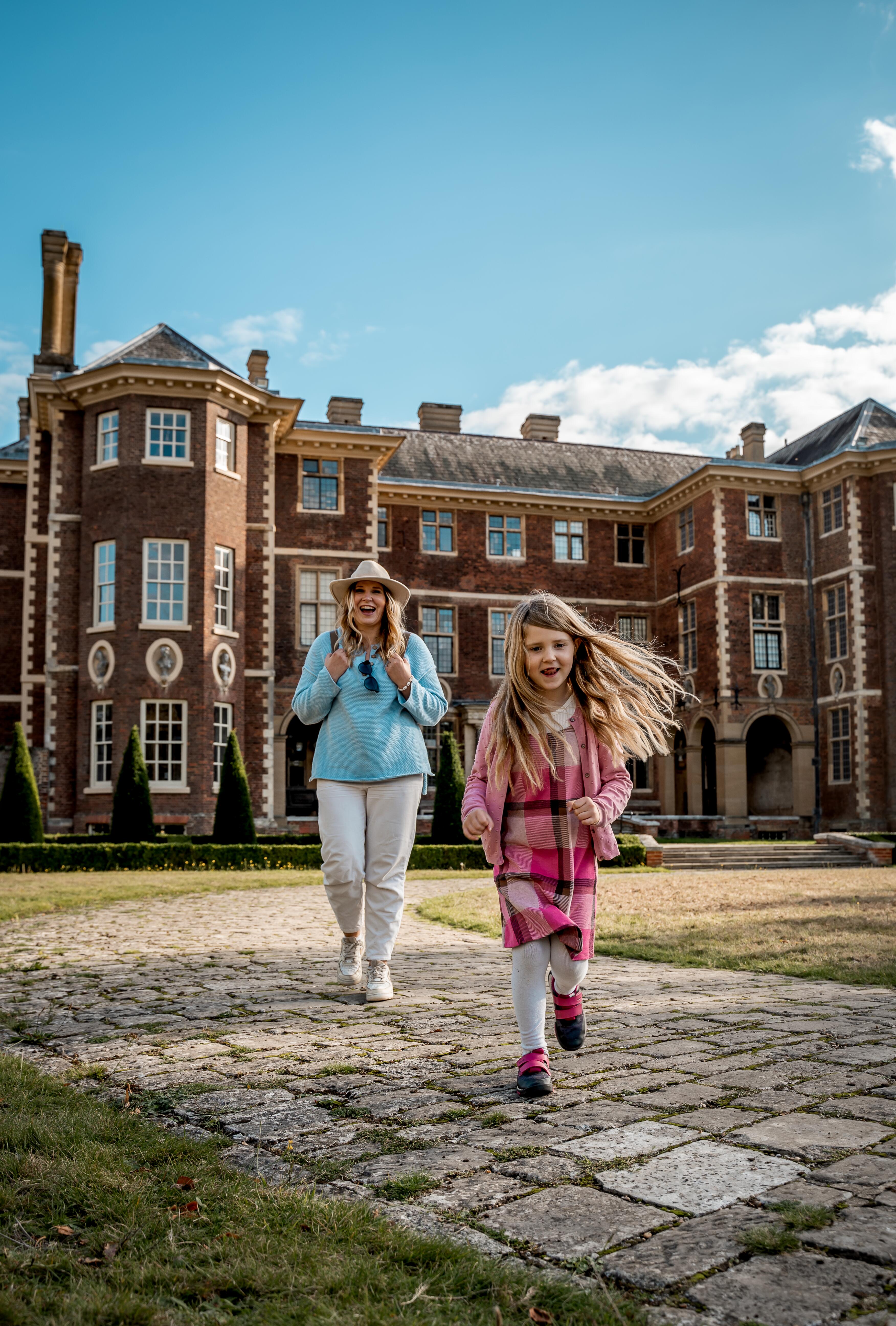 Woman and child in front of a country house