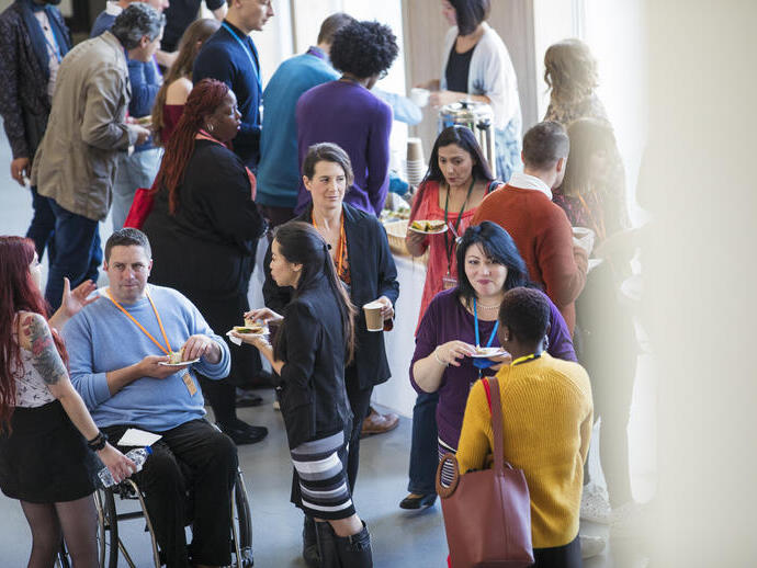 Group of people talking during a conference break