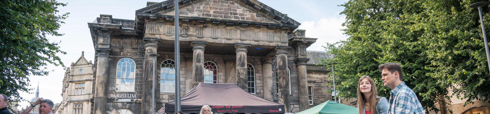 Groups of people exploring the city centre of Lancaster
