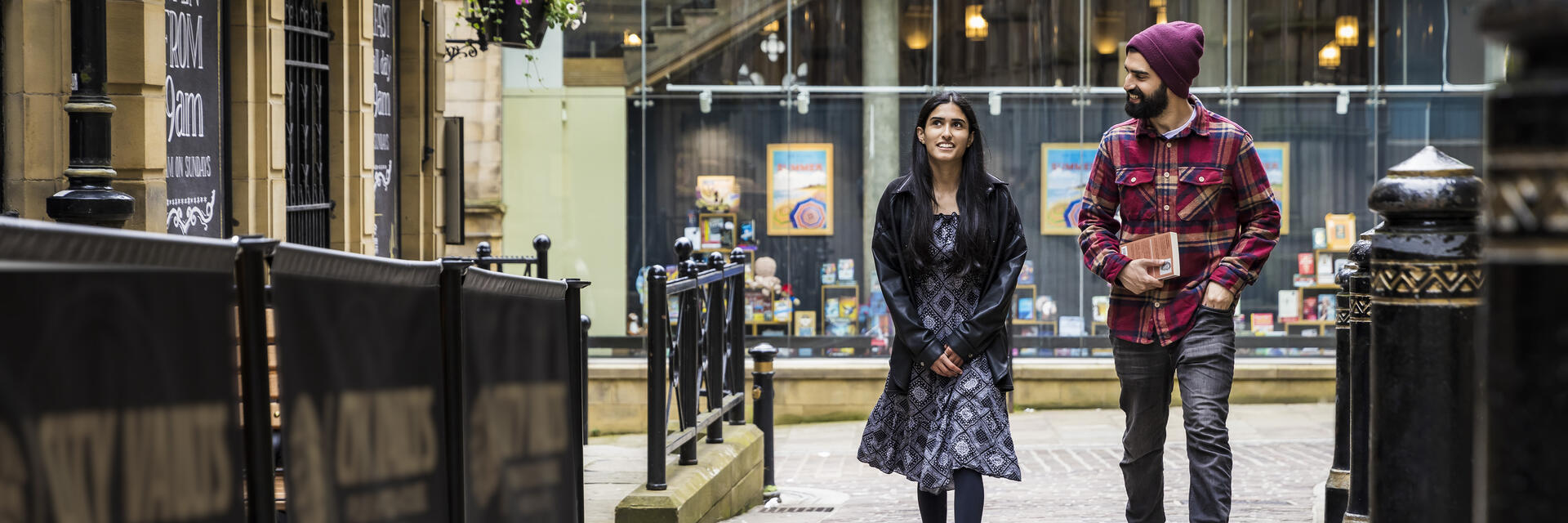 A woman and a man walk through a town centre