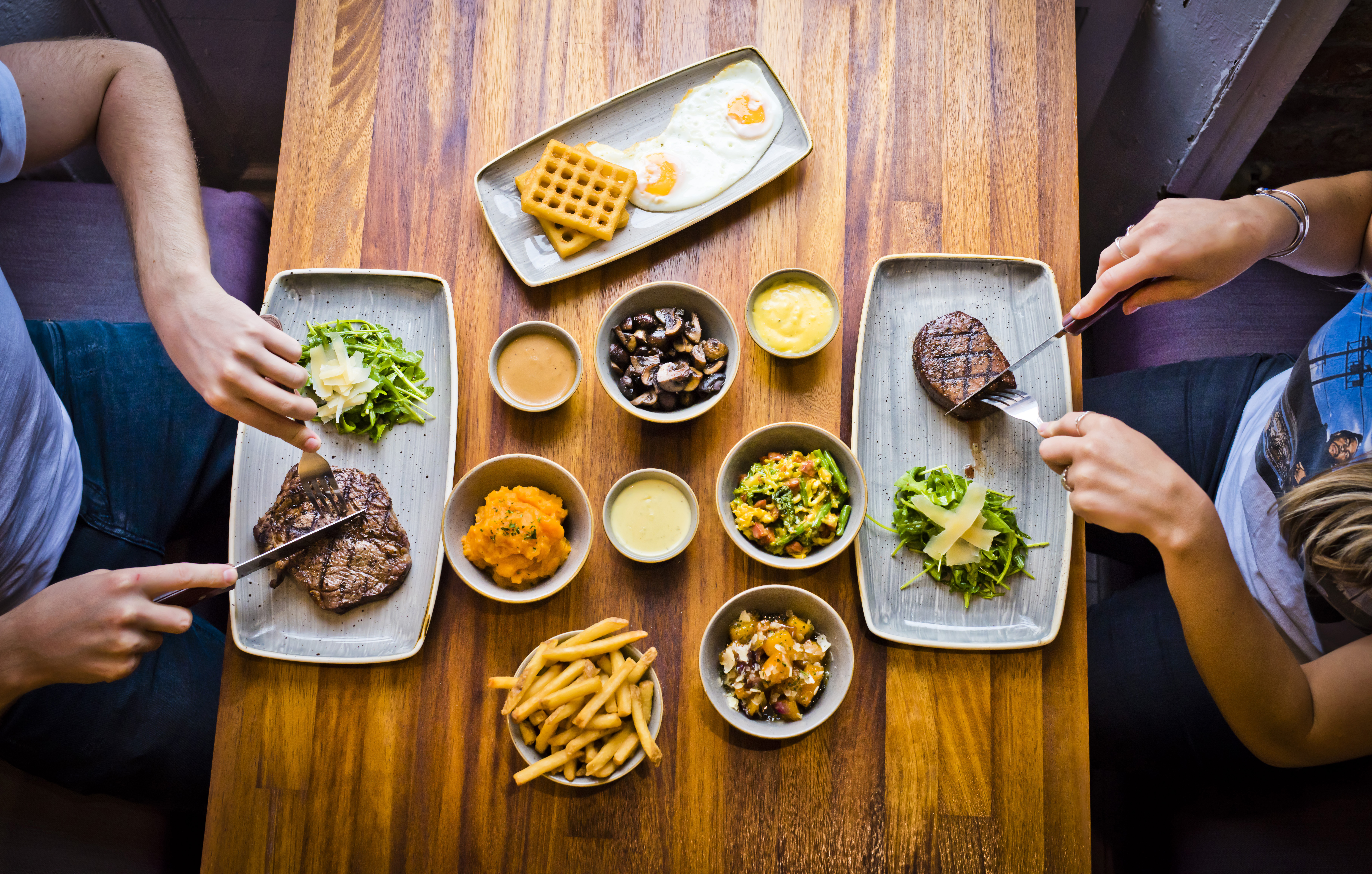 Two people eating steaks at Liverpool's Cowshed Restaurant