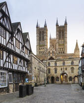 Cathedral with tudor timber framed medieval buildings in foreground