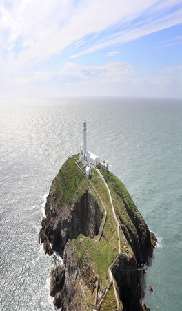 A lighthouse at the end of a peninsula