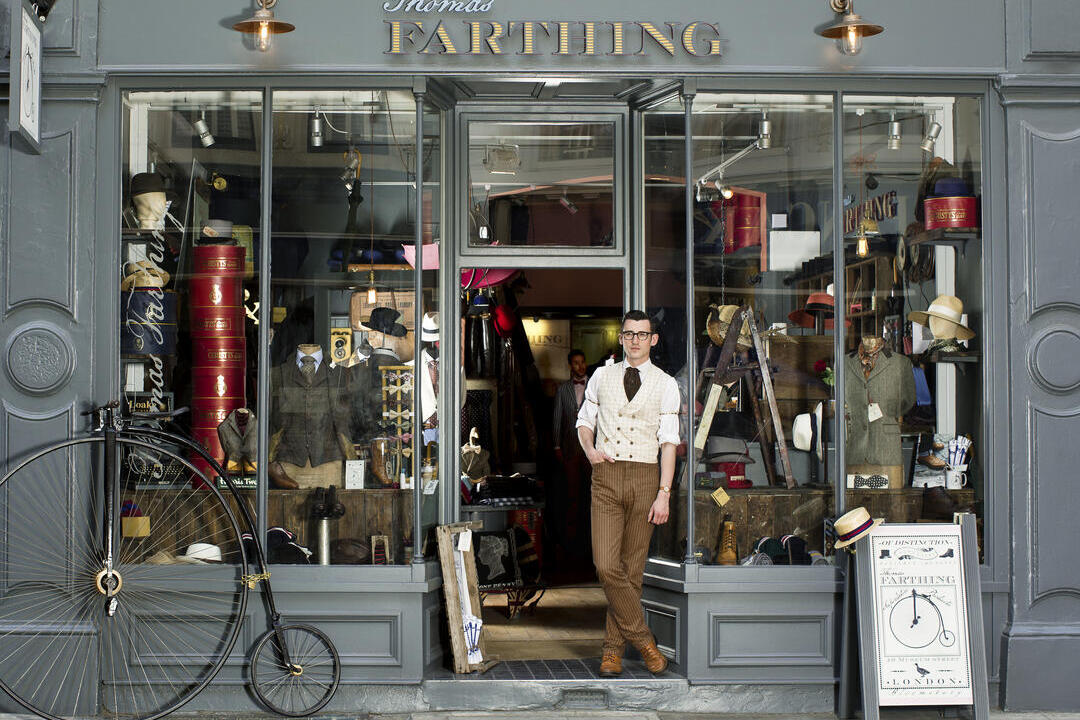 Man standing in the doorway of a shop selling retro goods