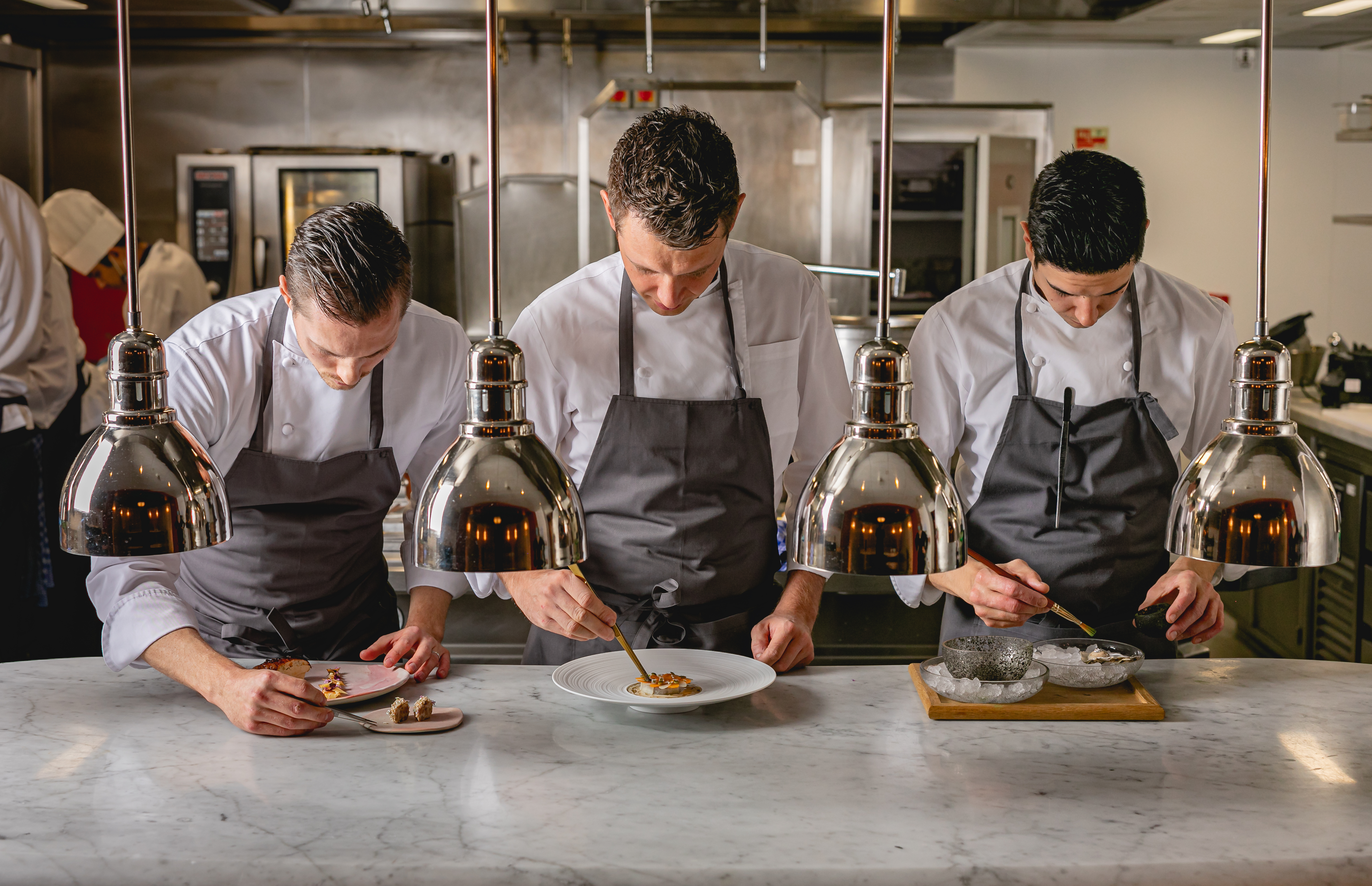 Chefs preparing food at counter, The Connaught