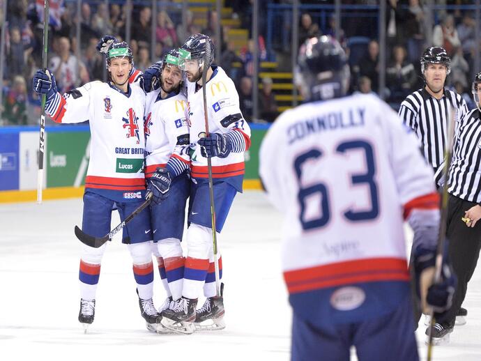 Group of three Great Britain ice hockey players celebrating on the ice together