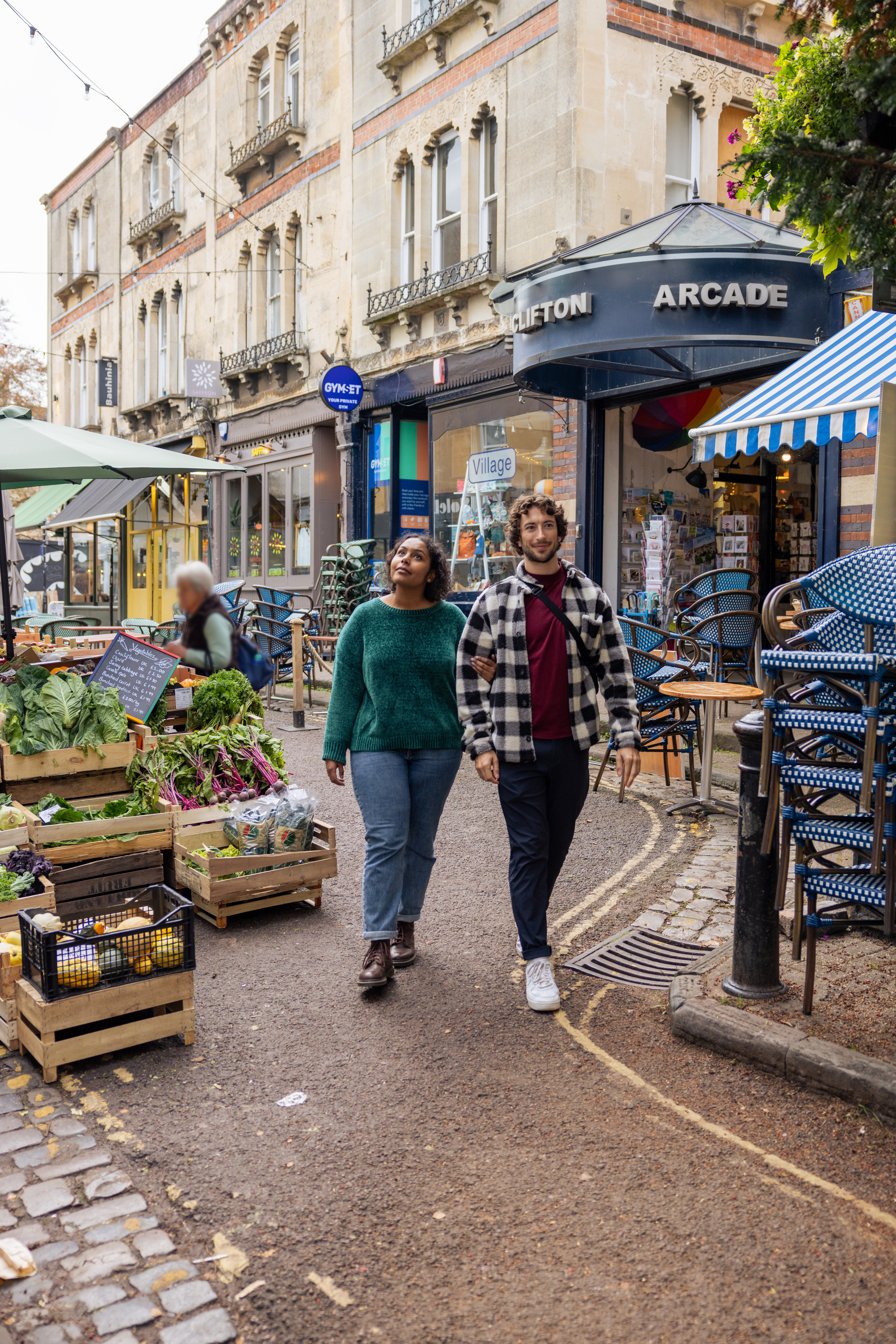 Friends walking through a market in a city street.