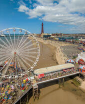 A busy seaside pier on a sunny day.