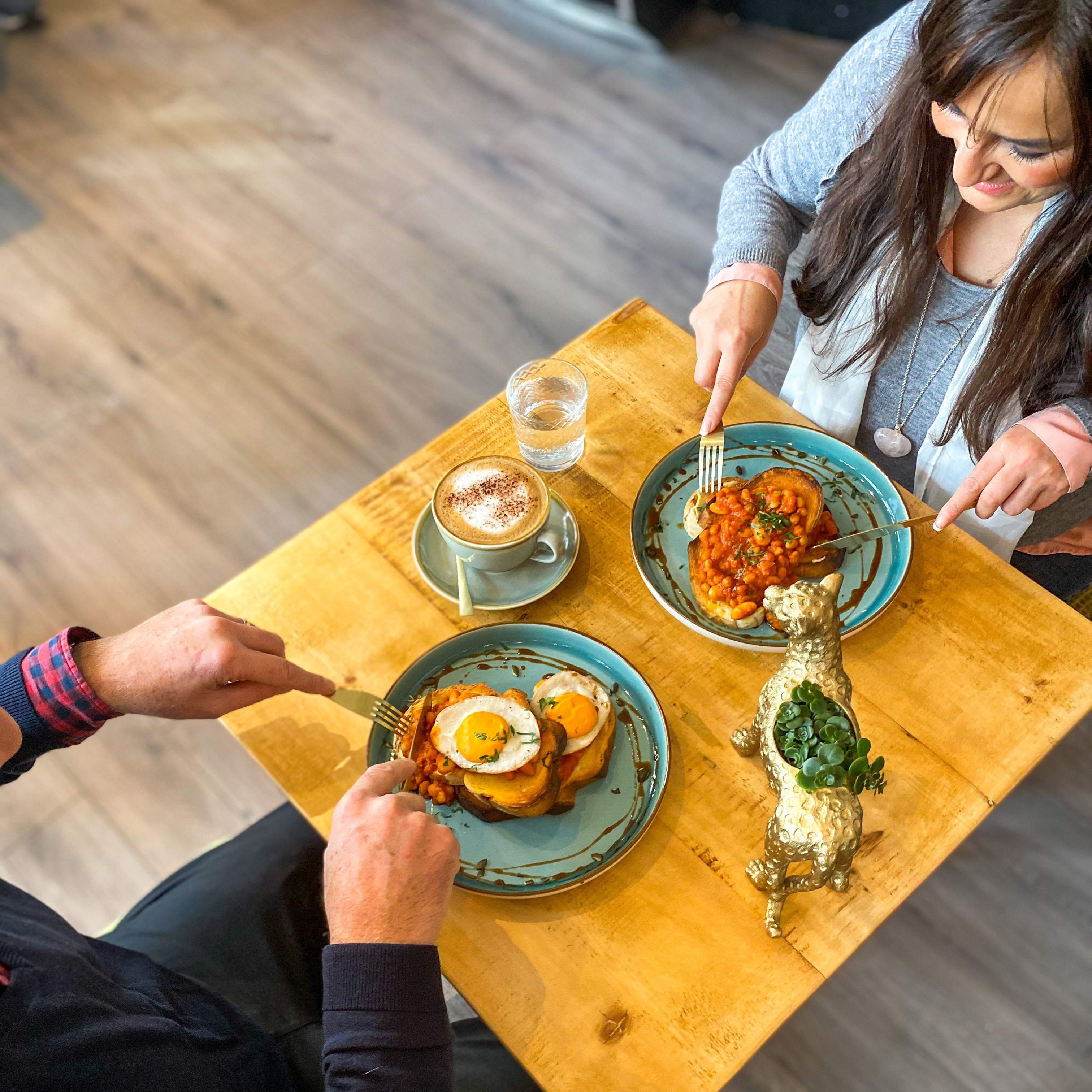 Persone che gustano il cibo a un tavolo del Vibe Cafe a Liverpool