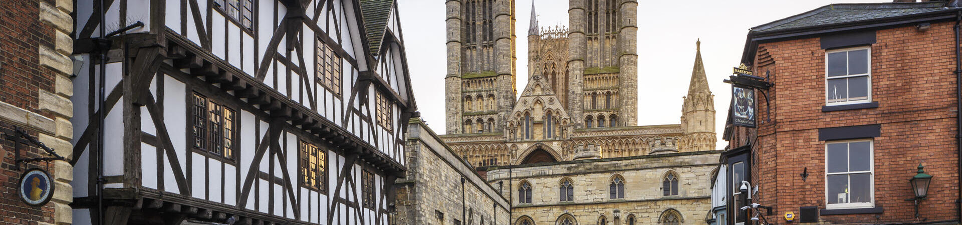 Cathedral with tudor timber framed medieval buildings in foreground