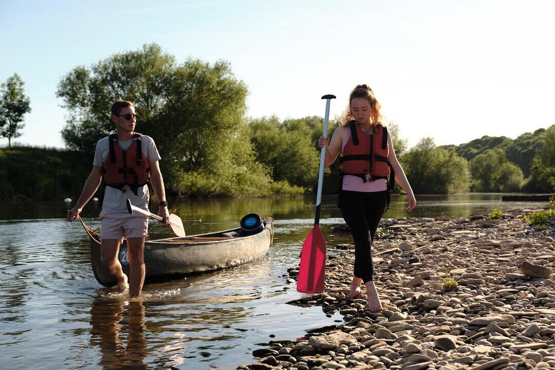 Two people canoeing on the River Wye