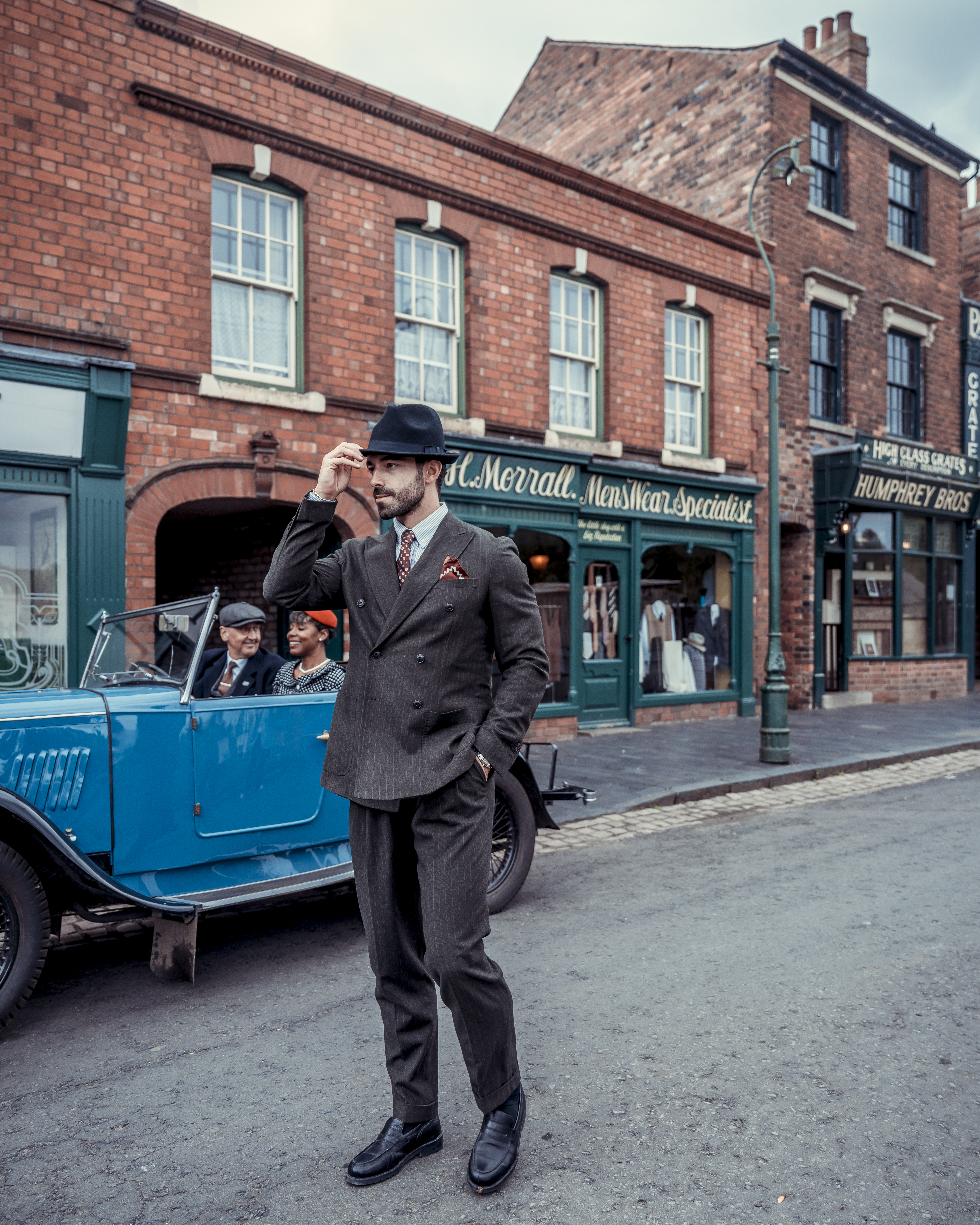 A man dressed in period costume visits a living museum