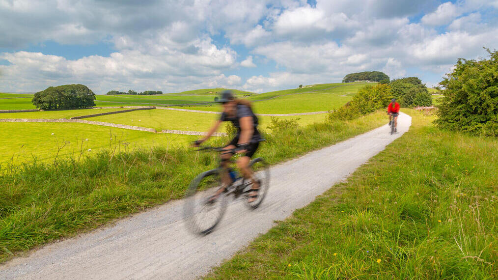 Two cyclists on a trail in the countryside