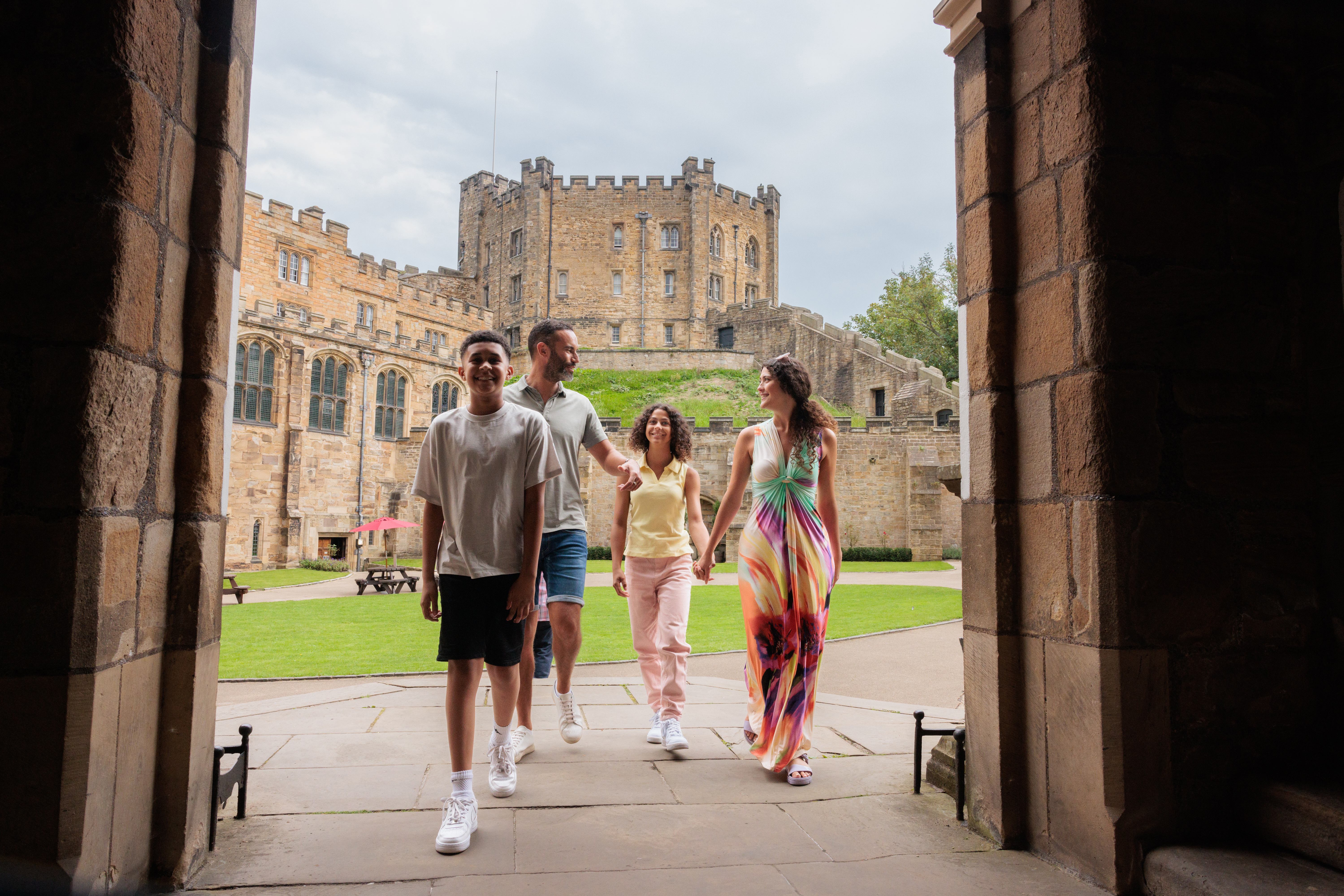 Family walking through an arch in the grounds of a cathedral