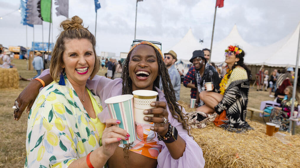 Two women having fun at a festival with friends