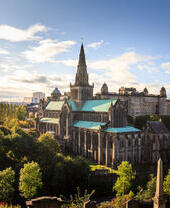 Aerial view of a cathedral on a sunny day with trees surrounding it