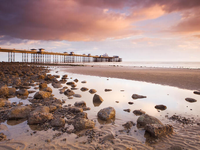 Pier built out into the sea in grand Edwardian style at dusk