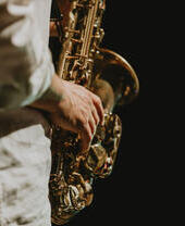A man playing a saxophone on stage.