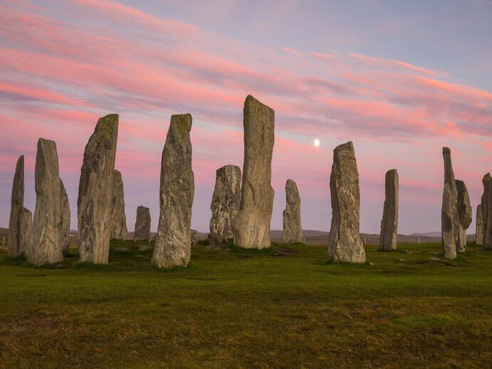Circle of standing stones at sunset