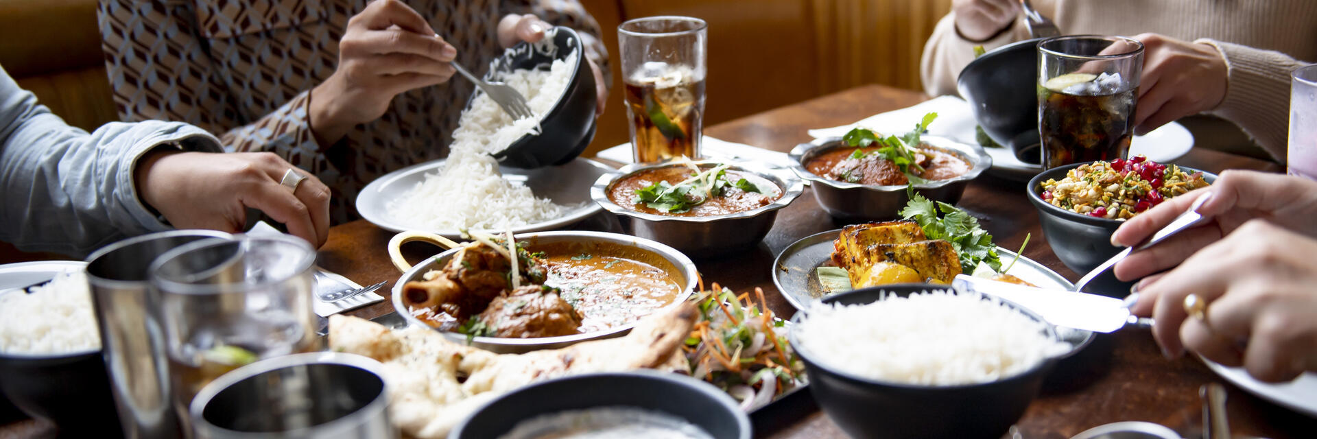 A group of people eating a meal at a table in a restaurant in Birmingham, West Midlands