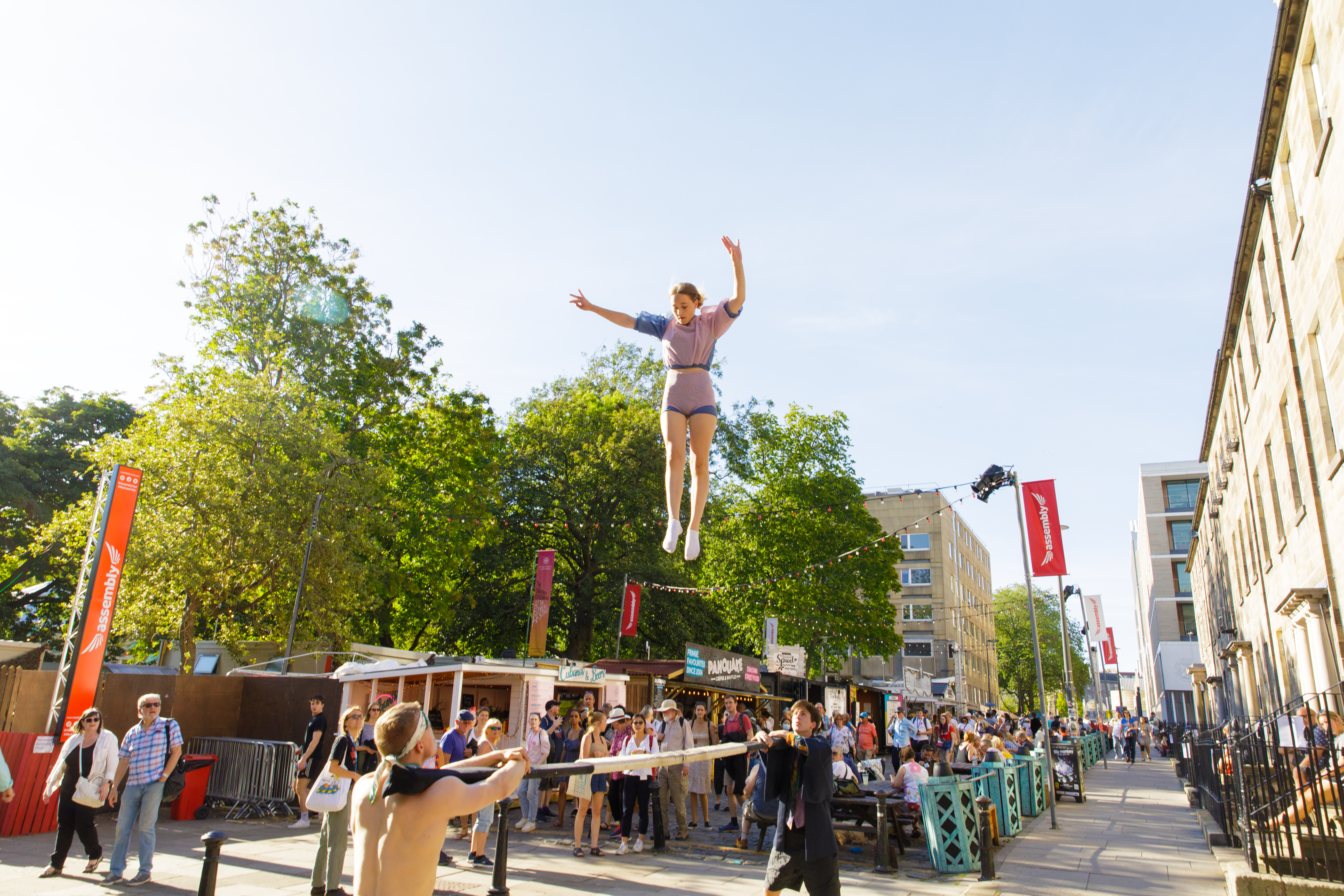 Street performers flyering on the Royal Mile in front of large crowd