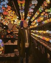 One young woman standing in a lighting shop