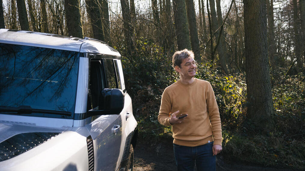 Man standing by a vehicle in a wood