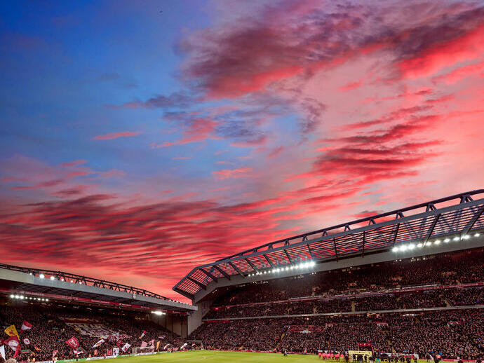 Red clouds in sunset over the ground of a stadium