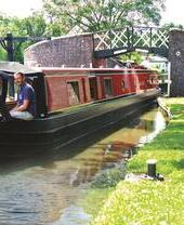 A family riding down a canal on a barge