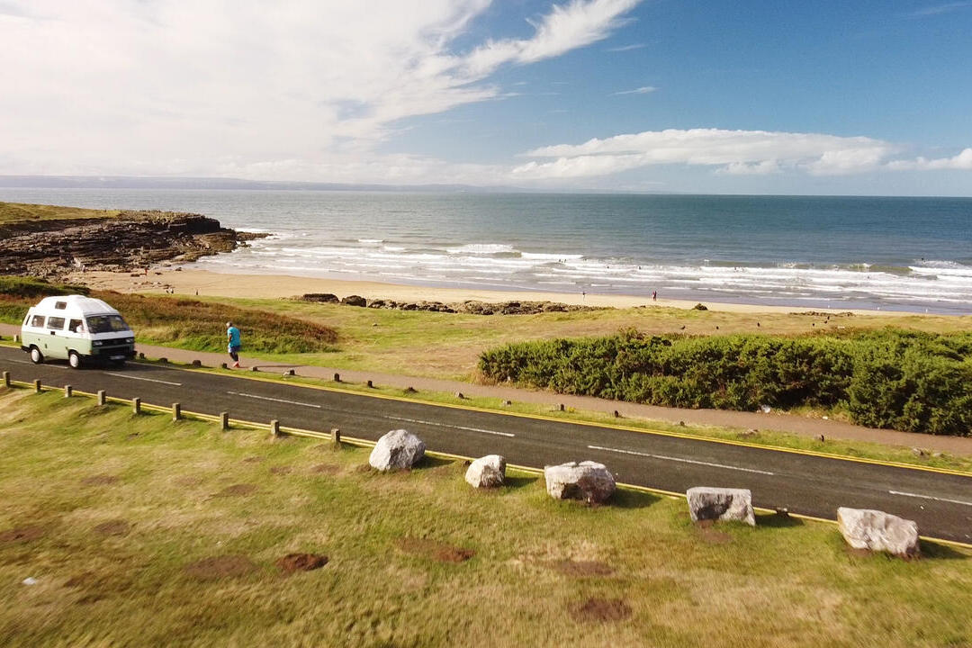 Campervan driving along a coastal road