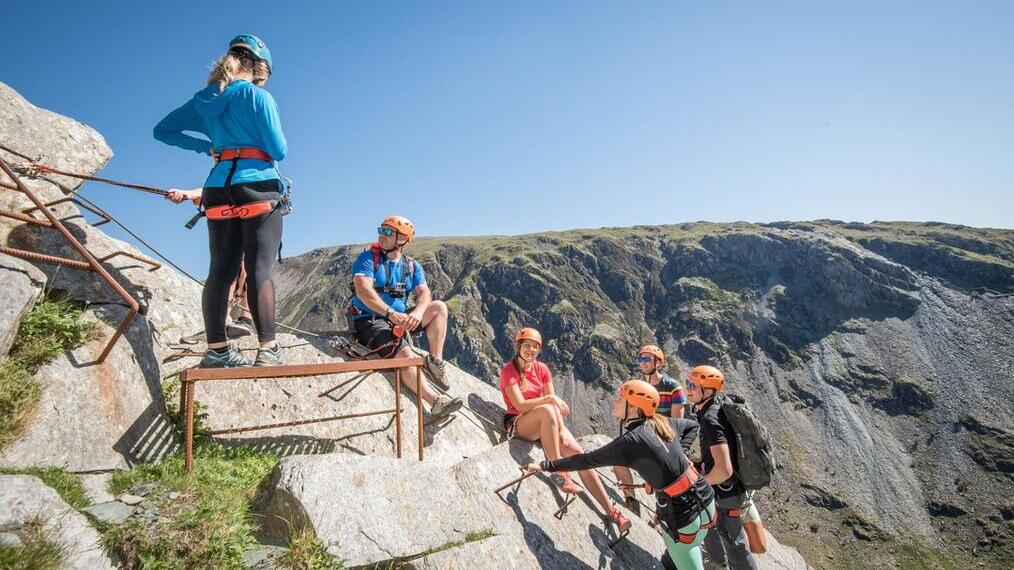 A group of people climbing up Honister Slate Mine